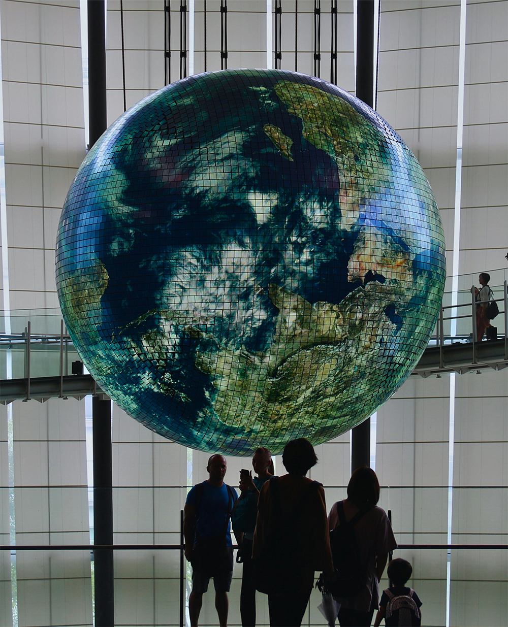 Science museum showing visitors looking at a model Earth